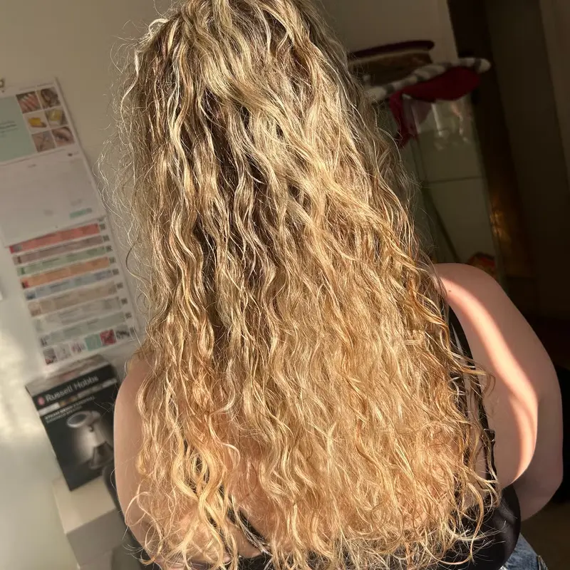 Natural curly blonde styled with definition and shine